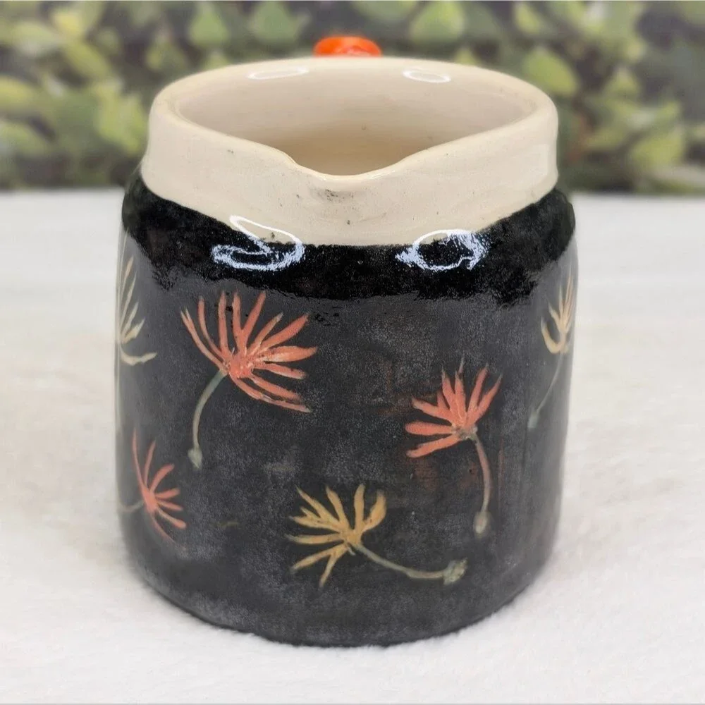 Handcrafted Black Ceramic Pitcher with Floral Design